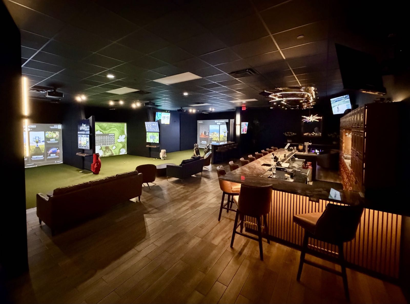 The five TrackMan bays and the members bar at The Office, a private golf club in North Palm Beach